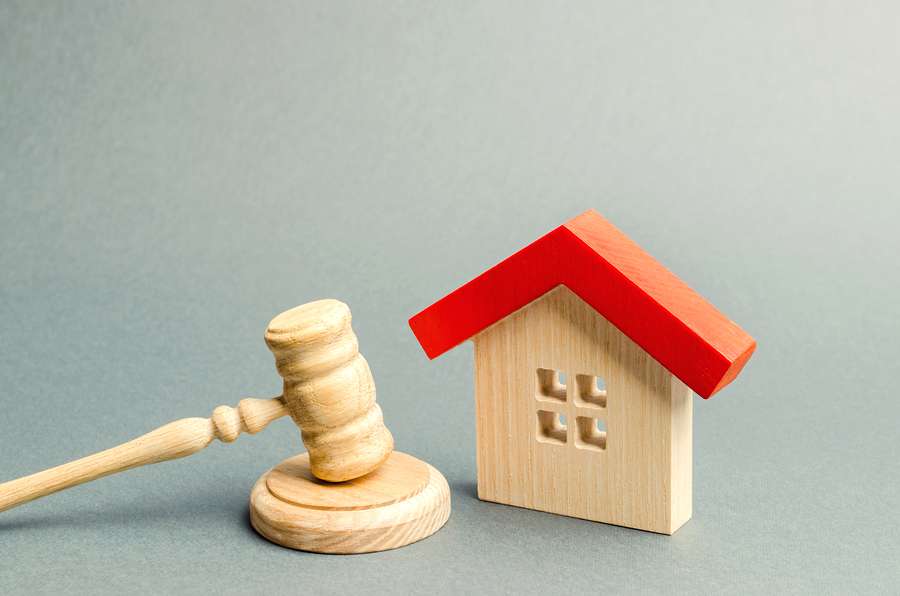 House and a gavel. Conveyancing concept